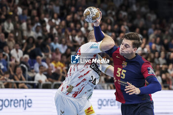 24/10/2024 - Domen Makuc of FC Barcelona and Christian O'Sullivan of SC Magdeburg during the EHF Champions League, Group Phase, handball match between FC Barcelona and SC Magdeburg on October 24, 2024 at Palau Blaugrana in Barcelona, Spain - HANDBALL - CHAMPIONS LEAGUE - BARCELONA V MAGDEBURG - PALLAMANO - ALTRO