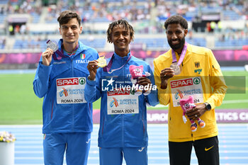 2024-06-09 - The half marathon podium at the 2024 European Athletics Championships. From left silver medalist Pietro Riva of Italy, center Yemaneberhan Crippa of Italy gold medalist and right Amanal Petros of Germany bronze medalist at the Olympic Stadium in Rome, June 9, 2024 - EUROPEAN ATHLETICS CHAMPIONSHIPS - INTERNATIONALS - ATHLETICS