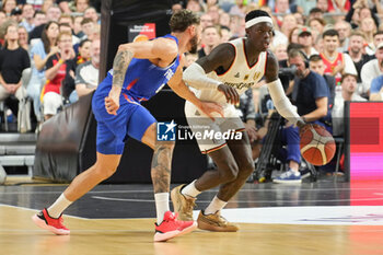 2024-07-06 - Dennis Schroder of Germany and Isaïa Cordinier of France during the International Friendly Basketball match between Germany and France on 6 July 2024 at Lanxess Arena in Cologne, Germany - BASKETBALL - FRIENDLY GAME - GERMANY V FRANCE - FRIENDLY MATCH - BASKETBALL