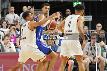 2024-07-06 - Victor Wembanyama of France and Oscar Da Silva of Germany during the International Friendly Basketball match between Germany and France on 6 July 2024 at Lanxess Arena in Cologne, Germany - BASKETBALL - FRIENDLY GAME - GERMANY V FRANCE - FRIENDLY MATCH - BASKETBALL