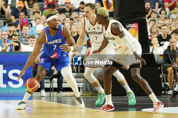 2024-07-06 - Guerschon Yabusele of France and Johannes Voigtmann, Isaac Bonga of Germany during the International Friendly Basketball match between Germany and France on 6 July 2024 at Lanxess Arena in Cologne, Germany - BASKETBALL - FRIENDLY GAME - GERMANY V FRANCE - FRIENDLY MATCH - BASKETBALL