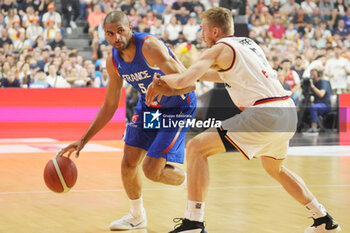 2024-07-06 - Nicolas Batum of France and Niels Giffey of Germany during the International Friendly Basketball match between Germany and France on 6 July 2024 at Lanxess Arena in Cologne, Germany - BASKETBALL - FRIENDLY GAME - GERMANY V FRANCE - FRIENDLY MATCH - BASKETBALL