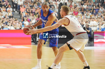 2024-07-06 - Nicolas Batum of France and Niels Giffey of Germany during the International Friendly Basketball match between Germany and France on 6 July 2024 at Lanxess Arena in Cologne, Germany - BASKETBALL - FRIENDLY GAME - GERMANY V FRANCE - FRIENDLY MATCH - BASKETBALL