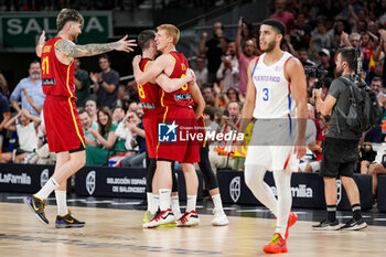 2024-07-23 - Juancho Hernangomez (L) celebrates with his teammates Dario Brizuela (C) and Alberto Diaz (R) of Spain during the Basketball International Friendly match between Spain and Puerto Rico at WiZink Center on July 23, 2024 in Madrid, Spain. - SPAIN VS PUERTO RICO - FRIENDLY MATCH - BASKETBALL