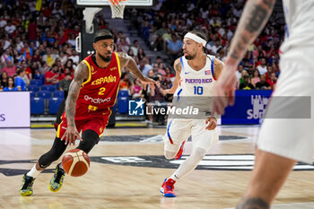 2024-07-23 - Lorenzo Brown (L) of Spain in action with the ball against Jose Alvarado (R) of Puerto Rico during the Basketball International Friendly match between Spain and Puerto Rico at WiZink Center on July 23, 2024 in Madrid, Spain. - SPAIN VS PUERTO RICO - FRIENDLY MATCH - BASKETBALL