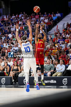 2024-07-23 - Lorenzo Brown (R) of Spain shoots the ball in front of Jose Alvarado (L) of Puerto Rico during the Basketball International Friendly match between Spain and Puerto Rico at WiZink Center on July 23, 2024 in Madrid, Spain. - SPAIN VS PUERTO RICO - FRIENDLY MATCH - BASKETBALL