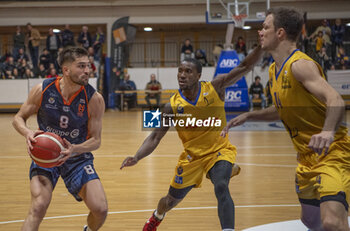 2024-03-29 - Vevey Switzerland, 03/29/2024: Thomas Salman of Union Neuchatel Basket #8 against Kyle Silva Oliveira of Vevey Riviera Basket #2 and Jonathan Dubas of Vevey Riviera Basket #14 during Playoffs for the Quarter of finals. Playoffs for the Quarter of finals which is also the 2nd Play-off match of the Swiss Basket League between Vevey Riviera Basket and Union Neuchatel Basket. - SWISS BASKET LEAGUE - VEVEY RIVIERA BASKET VS UNION NEUCHATEL BASKET - EVENTS - BASKETBALL
