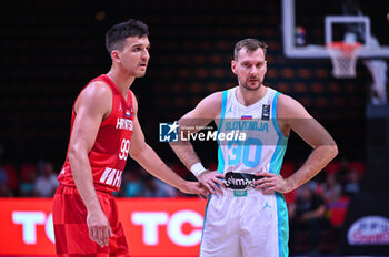 2024-07-02 - 30 Zoran Dragic of Slovenia competing with 99 Toni Nakic of Croatia during the FIBA Olympic Qualifying Tournament 2024, match between Slovenia and Croatia at Peace & Friendship Stadium on July 2, 2024, in Piraeus, Greece. - SLOVENIA VS CROATIA - FIBA OLYMPIC QUALIFYING TOURNAMENTS - INTERNATIONALS - BASKETBALL