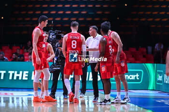 2024-07-02 - Head Coach Josip Sesar of Croatia with hia players during the FIBA Olympic Qualifying Tournament 2024, match between Slovenia and Croatia at Peace & Friendship Stadium on July 2, 2024, in Piraeus, Greece. - SLOVENIA VS CROATIA - FIBA OLYMPIC QUALIFYING TOURNAMENTS - INTERNATIONALS - BASKETBALL