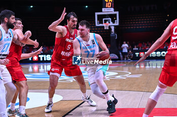 2024-07-02 - 77 Luka Doncic of Slovenia competing with 9 Dario Saric of Croatia during the FIBA Olympic Qualifying Tournament 2024, match between Slovenia and Croatia at Peace & Friendship Stadium on July 2, 2024, in Piraeus, Greece. - SLOVENIA VS CROATIA - FIBA OLYMPIC QUALIFYING TOURNAMENTS - INTERNATIONALS - BASKETBALL