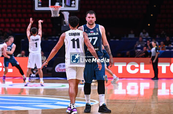 2024-07-04 - 77 Luka Doncic of Slovenia with 11 Flynn Cameron of New Zealand during the FIBA Olympic Qualifying Tournament 2024, match between Slovenia and New Zealand at Peace & Friendship Stadium on July 4, 2024, in Piraeus, Greece. - NEW ZEALAND VS SLOVENIA - FIBA OLYMPIC QUALIFYING TOURNAMENTS - INTERNATIONALS - BASKETBALL