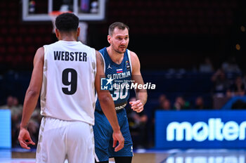 2024-07-04 - 30 Zoran Dragic of Slovenia with 9 Corey Webster of New Zealand during the FIBA Olympic Qualifying Tournament 2024, match between Slovenia and New Zealand at Peace & Friendship Stadium on July 4, 2024, in Piraeus, Greece. - NEW ZEALAND VS SLOVENIA - FIBA OLYMPIC QUALIFYING TOURNAMENTS - INTERNATIONALS - BASKETBALL