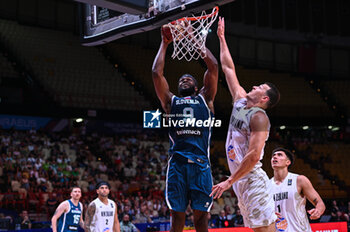 2024-07-04 - 9 Josh Nebo of Slovenia competing with 5 Yanni Wetzell of New Zealand during the FIBA Olympic Qualifying Tournament 2024, match between Slovenia and New Zealand at Peace & Friendship Stadium on July 4, 2024, in Piraeus, Greece. - NEW ZEALAND VS SLOVENIA - FIBA OLYMPIC QUALIFYING TOURNAMENTS - INTERNATIONALS - BASKETBALL