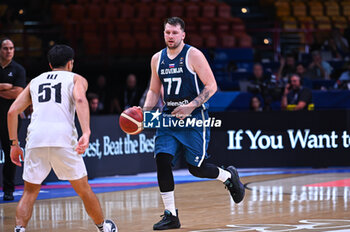 2024-07-04 - 77 Luka Doncic of Slovenia is playing during the FIBA Olympic Qualifying Tournament 2024, match between Slovenia and New Zealand at Peace & Friendship Stadium on July 4, 2024, in Piraeus, Greece. - NEW ZEALAND VS SLOVENIA - FIBA OLYMPIC QUALIFYING TOURNAMENTS - INTERNATIONALS - BASKETBALL