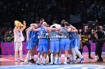 2024-07-07 - Players of Greece celebrating the ticket to the Olympic Games of Paris 2024 during the FIBA Olympic Qualifying Tournament 2024 Final match between Croatia and Greece at Peace & Friendship Stadium on July 7, 2024, in Piraeus, Greece. - CROATIA VS GREECE - FINAL, FIBA OLYMPIC QUALIFYING TOURNAMENTS - INTERNATIONALS - BASKETBALL