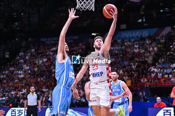 2024-07-07 - 23 Mateo Dreznjak of Croatia competing with 14 Georgios Papagiannis of Greece during the FIBA Olympic Qualifying Tournament 2024 Final match between Croatia and Greece at Peace & Friendship Stadium on July 7, 2024, in Piraeus, Greece. - CROATIA VS GREECE - FINAL, FIBA OLYMPIC QUALIFYING TOURNAMENTS - INTERNATIONALS - BASKETBALL