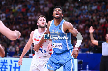 2024-07-07 - 34 Giannis Antetokounmpo of Greece competing with 23 Mateo Dreznjak of Croatia during the FIBA Olympic Qualifying Tournament 2024 Final match between Croatia and Greece at Peace & Friendship Stadium on July 7, 2024, in Piraeus, Greece. - CROATIA VS GREECE - FINAL, FIBA OLYMPIC QUALIFYING TOURNAMENTS - INTERNATIONALS - BASKETBALL