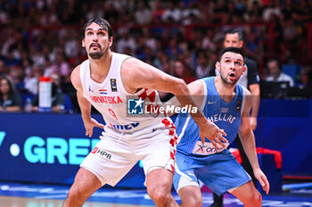 2024-07-07 - 9 Dario Saric of Croatia competing with 16 Kostas Papanikolaou of Greece during the FIBA Olympic Qualifying Tournament 2024 Final match between Croatia and Greece at Peace & Friendship Stadium on July 7, 2024, in Piraeus, Greece. - CROATIA VS GREECE - FINAL, FIBA OLYMPIC QUALIFYING TOURNAMENTS - INTERNATIONALS - BASKETBALL