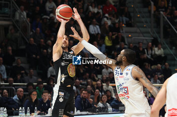2024-01-06 - Diego Monaldi (Apu Udine) thwarted by Mark Ogden (Fortitudo Flats Services Bologna) during the italian basketball LBN A2 series championship match Fortitudo Flats Services Bologna Vs Apu Old Wild West Udine - Bologna, Italy, January 06, 2024 at Paladozza sports hall - Photo: Michele Nucci - FORTITUDO BOLOGNA VS UDINE - ITALIAN SERIE A2 - BASKETBALL