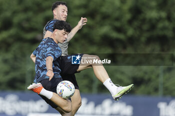 2024-07-11 - Napoli's Italian forward Giuseppe Ambrosino challenges for the ball with Napoli's Kosovar defender Amir Rrahmani during SSC Napoli's 2024-25 preseason training camp in val di sole in Trentino, Dimaro Folgarida

 - SSC NAPOLI TRAINING - OTHER - SOCCER