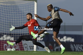 2024-07-11 - Napoli's Nigerian forward Victor Osimhen challenges for the ball with Napoli's Italian goalkeeper Nikita Contini during SSC Napoli's 2024-25 preseason training camp in val di sole in Trentino, Dimaro Folgarida

 - SSC NAPOLI TRAINING - OTHER - SOCCER