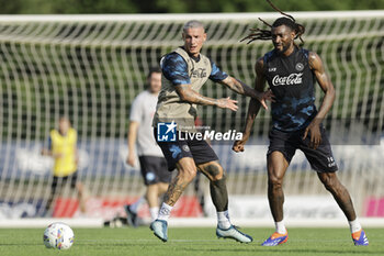 2024-07-11 - Napoli's Italian defender Pasquale Mazzocchi (L) challenges for the ball with Napoli's Cameroonian midfielder Andre Frank Zambo Anguissa during SSC Napoli's 2024-25 preseason training camp in val di sole in Trentino, Dimaro Folgarida

 - SSC NAPOLI TRAINING - OTHER - SOCCER