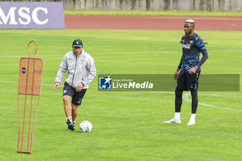 2024-07-12 - Napoli’s Italian coach Antonio Conte gesticulate with Napoli's Nigerian forward Victor Osimhen during SSC Napoli's 2024-25 preseason training camp in val di sole in Trentino, Dimaro Folgarida

 - SSC NAPOLI TRAINING - OTHER - SOCCER