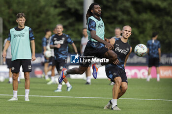 2024-07-12 - Napoli's Cameroonian midfielder Andre Frank Zambo Anguissa challenges for the ball with Napoli's Norwegian defender Leo Ostigard during SSC Napoli's 2024-25 preseason training camp in val di sole in Trentino, Dimaro Folgarida

 - SSC NAPOLI TRAINING - OTHER - SOCCER