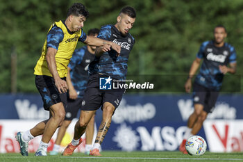 2024-07-13 - Napoli's Italian midfielder Gianluca Gaetano challenges for the ball with Napoli's Argentinian forward Giovanni Simeone during SSC Napoli's 2024-25 preseason training camp in val di sole in Trentino, Dimaro Folgarida

 - SSC NAPOLI TRAINING - OTHER - SOCCER