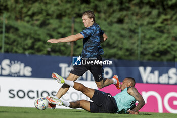 2024-07-13 - Napoli's Italian midfielder Alessio Zerbin challenges for the ball with Napoli's Brazilian defender Natan during SSC Napoli's 2024-25 preseason training camp in val di sole in Trentino, Dimaro Folgarida

 - SSC NAPOLI TRAINING - OTHER - SOCCER