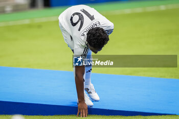 2024-07-27 - Endrick Felipe Moreira de Sousa touches the playing field with Real Madrid jersey during his presentation at Estadio Santiago Bernabeu on July 27, 2024 in Madrid, Spain. - REAL MADRID UNVEILS NEW SIGNING ENDRICK - OTHER - SOCCER