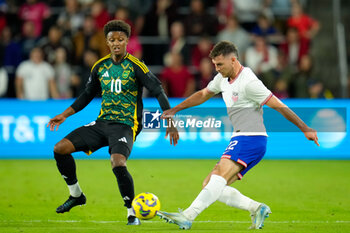 2024-11-18 - United States defender Joe Scally (22) passes the ball against Jamaica forward Demarai Gray (10) - CONCACAF NATIONS LEAGUE - USA VS JAMAICA - OTHER - SOCCER