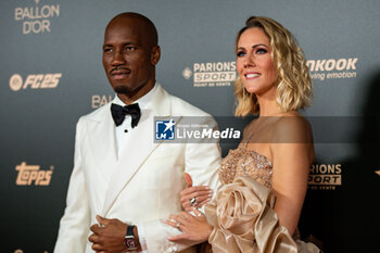 2024-10-28 - Didier Drogba and Sandy Heribert during the red carpet ceremony of the Ballon d'Or (Golden Ball) France Football 2024 on 28 October 2024 at Theatre du Chatelet in Paris, France - FOOTBALL - BALLON D'OR 2024 - RED CARPET CEREMONY - OTHER - SOCCER