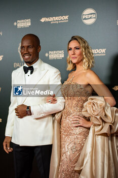 2024-10-28 - Didier Drogba and Sandy Heribert during the red carpet ceremony of the Ballon d'Or (Golden Ball) France Football 2024 on 28 October 2024 at Theatre du Chatelet in Paris, France - FOOTBALL - BALLON D'OR 2024 - RED CARPET CEREMONY - OTHER - SOCCER