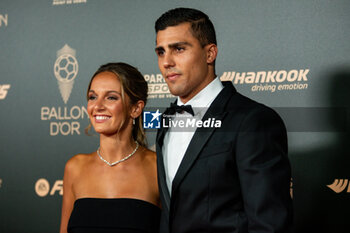 2024-10-28 - Rodrigo Hernandez Cascante and Laura Iglesias during the red carpet ceremony of the Ballon d'Or (Golden Ball) France Football 2024 on 28 October 2024 at Theatre du Chatelet in Paris, France - FOOTBALL - BALLON D'OR 2024 - RED CARPET CEREMONY - OTHER - SOCCER