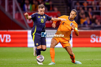 2024-03-22 - Lawrence Shankland of Scotland battles for possession with Virgil van Dijk of Netherlands during the International Friendly football match between Netherlands and Scotland on March 22, 2024 at Johan Cruijff ArenA in Amsterdam, Netherlands - FOOTBALL - FRIENDLY GAME - NETHERLANDS V SCOTLAND - FRIENDLY MATCH - SOCCER