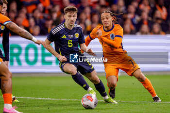 2024-03-22 - Kieran Tierney of Scotland battles for possession with Xavi Simons of Netherlands during the International Friendly football match between Netherlands and Scotland on March 22, 2024 at Johan Cruijff ArenA in Amsterdam, Netherlands - FOOTBALL - FRIENDLY GAME - NETHERLANDS V SCOTLAND - FRIENDLY MATCH - SOCCER