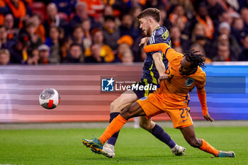 2024-03-22 - Ryan Christie of Scotland battles for possession with Jeremie Frimpong of Netherlands during the International Friendly football match between Netherlands and Scotland on March 22, 2024 at Johan Cruijff ArenA in Amsterdam, Netherlands - FOOTBALL - FRIENDLY GAME - NETHERLANDS V SCOTLAND - FRIENDLY MATCH - SOCCER