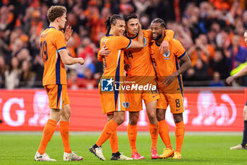 2024-03-22 - Tijjani Reijnders of Netherlands celebrates the first goal with Nathan Ake, Georginio Wijnaldum during the International Friendly football match between Netherlands and Scotland on March 22, 2024 at Johan Cruijff ArenA in Amsterdam, Netherlands - FOOTBALL - FRIENDLY GAME - NETHERLANDS V SCOTLAND - FRIENDLY MATCH - SOCCER
