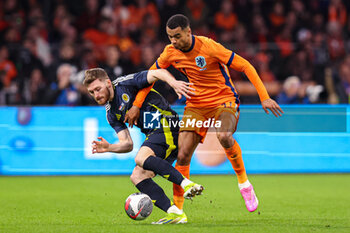 2024-03-22 - Anthony Ralston of Scotland, Cody Gakpo of Netherlands during the International Friendly football match between Netherlands and Scotland on March 22, 2024 at Johan Cruijff ArenA in Amsterdam, Netherlands - FOOTBALL - FRIENDLY GAME - NETHERLANDS V SCOTLAND - FRIENDLY MATCH - SOCCER