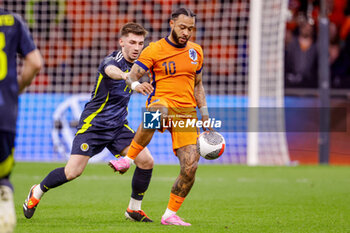 2024-03-22 - Billy Gilmour of Scotland battles for possession with Memphis Depay of Netherlands during the International Friendly football match between Netherlands and Scotland on March 22, 2024 at Johan Cruijff ArenA in Amsterdam, Netherlands - FOOTBALL - FRIENDLY GAME - NETHERLANDS V SCOTLAND - FRIENDLY MATCH - SOCCER