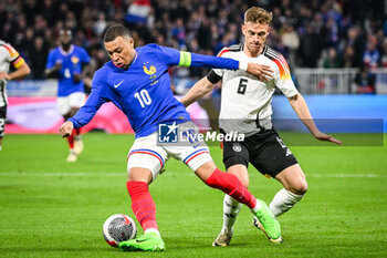 2024-03-23 - Kylian MBAPPE of France and Joshua KIMMICH of Germany during the International Friendly football match between France and Germany on March 23, 2024 at Groupama stadium in Decines-Charpieu near Lyon, France - FOOTBALL - FRIENDLY GAME - FRANCE V GERMANY - FRIENDLY MATCH - SOCCER