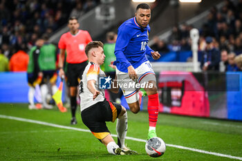 2024-03-23 - Joshua KIMMICH of Germany and Kylian MBAPPE of France during the International Friendly football match between France and Germany on March 23, 2024 at Groupama stadium in Decines-Charpieu near Lyon, France - FOOTBALL - FRIENDLY GAME - FRANCE V GERMANY - FRIENDLY MATCH - SOCCER