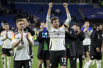 2024-03-23 - Joshua Kimmich and Thomas Muller of Germany salute the supporters following the International Friendly football match between France and Germany on March 23, 2024 at Groupama stadium in Decines-Charpieu near Lyon, France - FOOTBALL - FRIENDLY GAME - FRANCE V GERMANY - FRIENDLY MATCH - SOCCER
