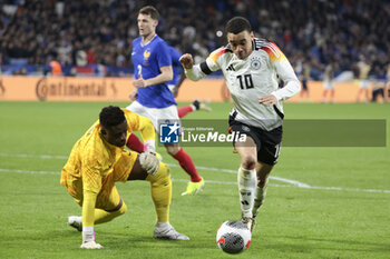 2024-03-23 - Jamal Musiala of Germany, left Goalkeeper of France Brice Samba during the International Friendly football match between France and Germany on March 23, 2024 at Groupama stadium in Decines-Charpieu near Lyon, France - FOOTBALL - FRIENDLY GAME - FRANCE V GERMANY - FRIENDLY MATCH - SOCCER