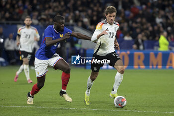 2024-03-23 - Thomas Muller of Germany, left Dayot Upamecano of France during the International Friendly football match between France and Germany on March 23, 2024 at Groupama stadium in Decines-Charpieu near Lyon, France - FOOTBALL - FRIENDLY GAME - FRANCE V GERMANY - FRIENDLY MATCH - SOCCER