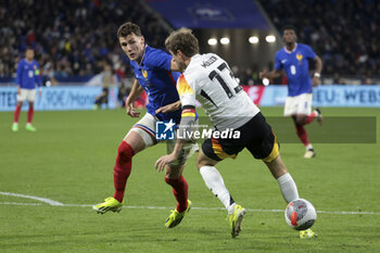 2024-03-23 - Benjamin Pavard of France, Thomas Muller of Germany during the International Friendly football match between France and Germany on March 23, 2024 at Groupama stadium in Decines-Charpieu near Lyon, France - FOOTBALL - FRIENDLY GAME - FRANCE V GERMANY - FRIENDLY MATCH - SOCCER