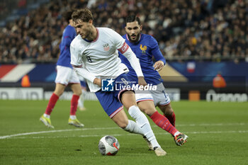 2024-03-25 - Tanner Tessmand of USA, Rayan Cherki of France during the International Under 23 Friendly football match between France U23 and United States, USA U23 on March 25, 2024 at Stade Auguste Bonal in Sochaux Montbeliard, France - FOOTBALL - U23 FRIENDLY GAME - FRANCE V USA - FRIENDLY MATCH - SOCCER