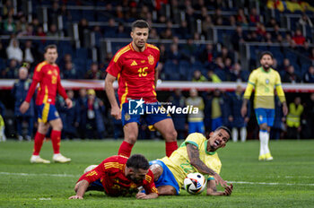 2024-03-26 - Daniel Carvajal of Spain (L) causes a foul on Wenderson Galeno of Brazil (R) during the friendly football match among the national teams of Spain and Brazil at Estadio Santiago Bernabeu, Madrid. - SPAIN VS BRAZIL - FRIENDLY MATCH - SOCCER