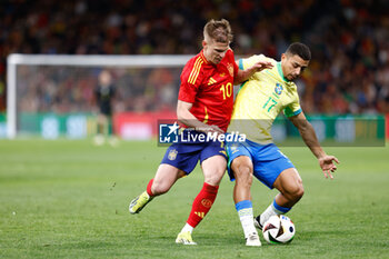2024-03-26 - Andre Trindade da Costa Neto of Brazil and Dani Olmo of Spain during the International friendly football match between Spain and Brazil on March 26, 2024 at Santiago Bernabeu stadium in Madrid, Spain - FOOTBALL - FRIENDLY GAME - SPAIN V BRAZIL - FRIENDLY MATCH - SOCCER